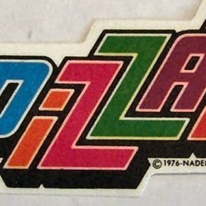 May include: A vintage sticker with the word "PIZZAL" in colorful, layered letters. The letters are outlined in black and the background is white. The sticker has the copyright information "© 1976-NADEL S.T.C. N.Y.C."