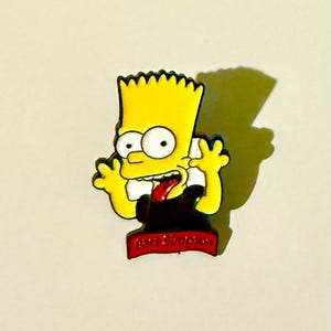 May include: A yellow cartoon character with spiky hair, large eyes, and a red tongue sticking out. The character is wearing a black shirt and has the name "Bart Simpson" on a red banner below.