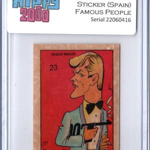 May include: A vintage trading card featuring a cartoon illustration of Roger Moore, holding a gun and cigarette, against a red background. The card is from the 1973 Hippy 2000 Famous People series, made in Spain. The card is encased in a protective holder.