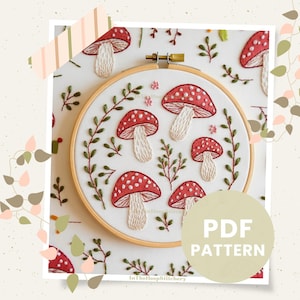 May include: Embroidery pattern for a hoop featuring red and white mushrooms with white stems and green leaves. The pattern is titled "PDF PATTERN".