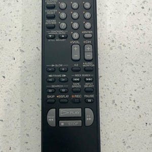 May include: Black Sony VTR/TV remote control with numerous buttons for TV, VTR, and VHS functions. Features buttons for power, menu, cursor, and numeric keys. The remote has the text "SONY VTR/TV RMT-V154C VHS" printed on it.