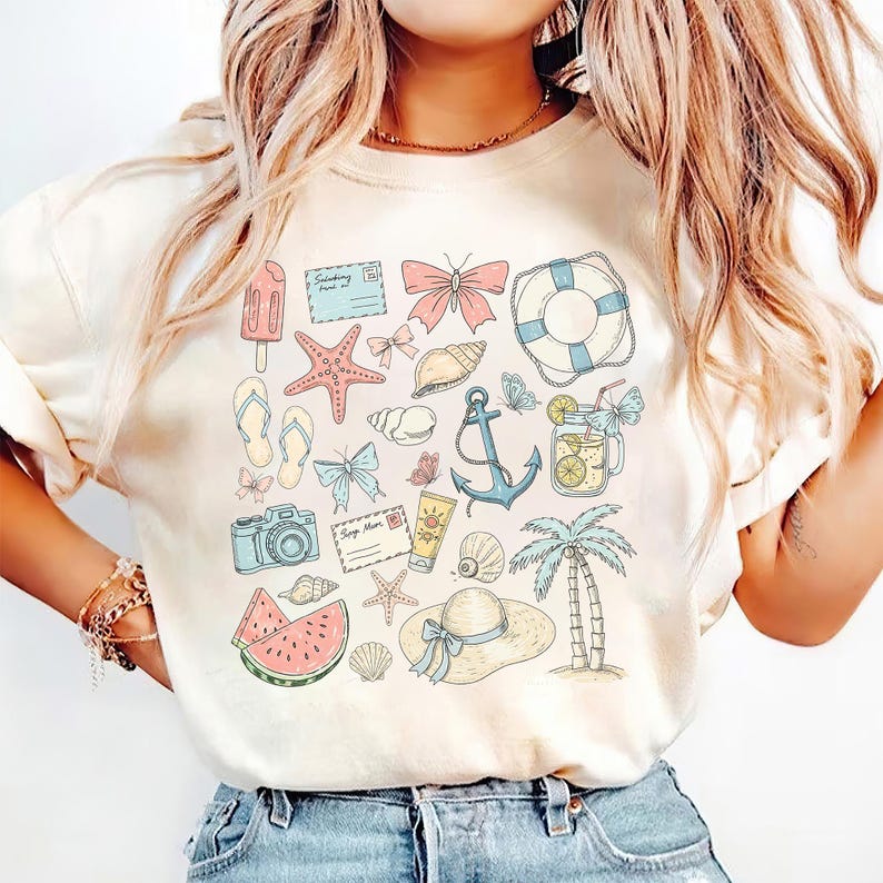 May include: A white t-shirt with a summer-themed design featuring a variety of illustrations, including a watermelon, seashells, a camera, a palm tree, an anchor, a life preserver, butterflies, and a starfish.