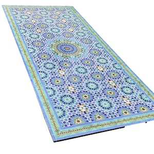 Peut inclure: Un plateau de table rectangulaire présentant un motif géométrique complexe en mosaïque dans des tons de bleu, turquoise, blanc et marron. Le design se compose de motifs en étoile répétitifs et d'un médaillon central, bordé d'une frise.
