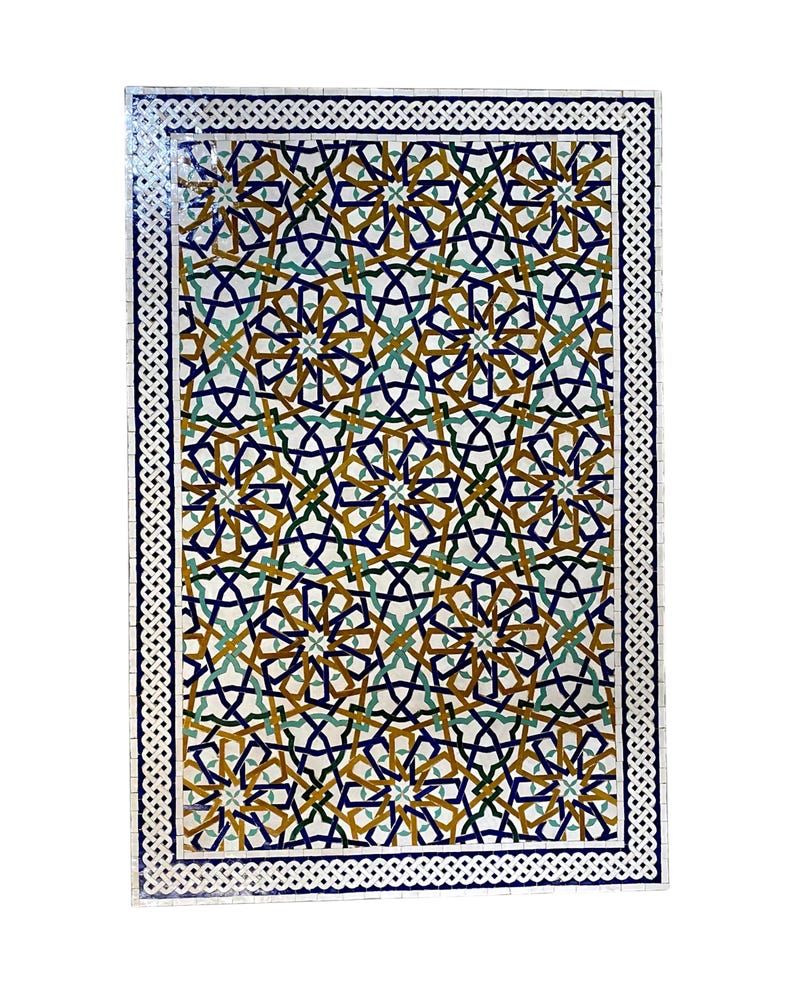 May include: A rectangular mosaic tile panel featuring an intricate geometric pattern of interlocking stars and lines in shades of deep blue, mustard yellow, and teal green, framed by a white and blue braided border on a white background.