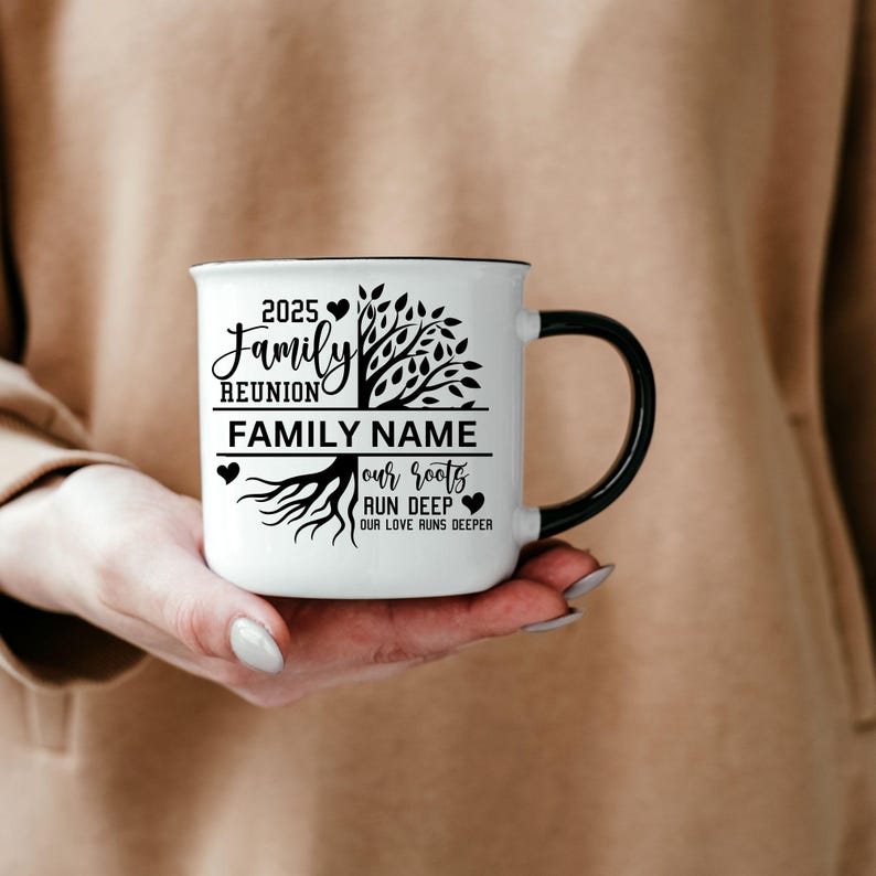 May include: White ceramic mug with a black handle. The mug has a black design of a tree with roots and the text "2025 Family Reunion FAMILY NAME our roots run deep our love runs deeper".