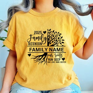 May include: A yellow t-shirt with a black family reunion design. The design features a tree with roots and the text "2025 Family Reunion", "FAMILY NAME", "our roots run deep", and "our love runs deeper".