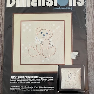 May include: A Dimensions candlewicking kit featuring a teddy bear patchwork design. The kit includes a 12"x12" frame size or a 12"x12" pillow size (30x30cm). The design is printed on cotton muslin fabric. The package includes the text "TEDDY BEAR PATCHWORK".