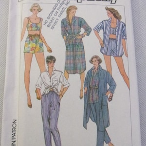May include: Simplicity sewing pattern number 380 for sizes 10-12-14 and 50-40-42. The pattern includes five different clothing designs: a short-sleeved shirt with a tie at the waist, a long-sleeved shirt with a tie at the waist, a short-sleeved shirt with a tie at the waist, a long-sleeved shirt with a tie at the waist, and a pair of pants.