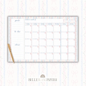 May include: A monthly planner with a pastel pink and blue bow and floral design. The planner includes sections for goals, to-dos, and ideas, with a grid for daily scheduling. A gold pen rests on the side.