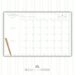 May include: A white monthly planner with a light green scalloped border and grid. The planner includes sections for goals, to-do lists, and ideas. A gold pen rests on the left side. The text "chelsea's month of" is visible.