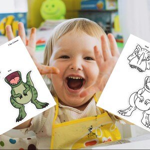 May include: Two white sheets with T-Rex cutouts. One sheet has a green dinosaur head and body, the other has a black and white dinosaur head and body. The child in the image is smiling and has their hands up.