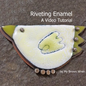 May include: A yellow and green enamel bird with black details and silver rivets. The bird is on a brown background. The text "Riveting Enamel A Video Tutorial by My Brown Wren" is below the bird.