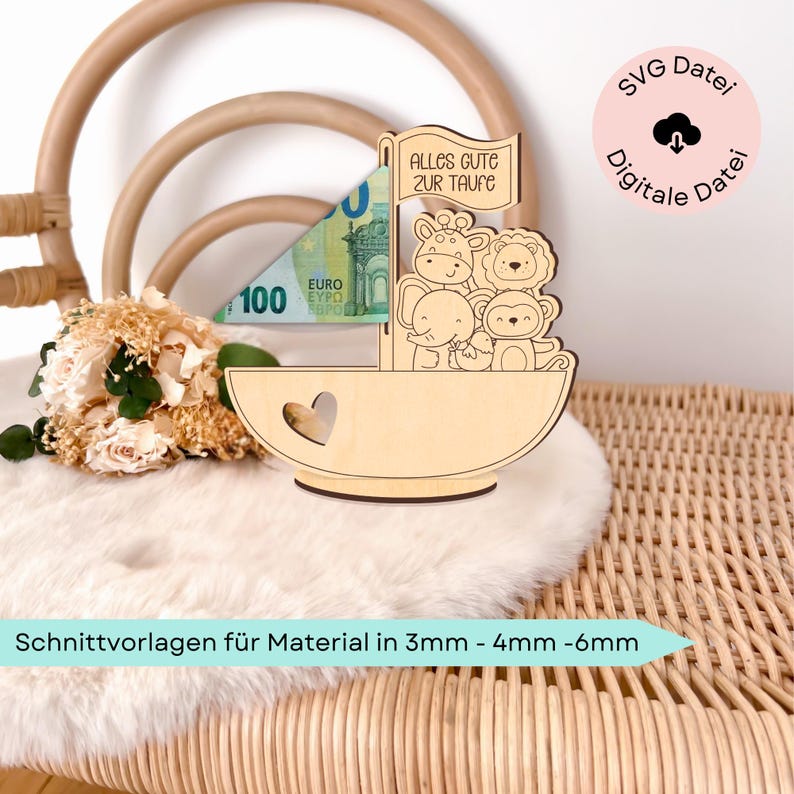 May include: Wooden sailboat money holder with a heart cutout and a banner that reads "Alles Gute zur Taufe". The sailboat is decorated with a giraffe, lion, elephant, and monkey. The sailboat is sitting on a wicker chair with a white faux fur throw.