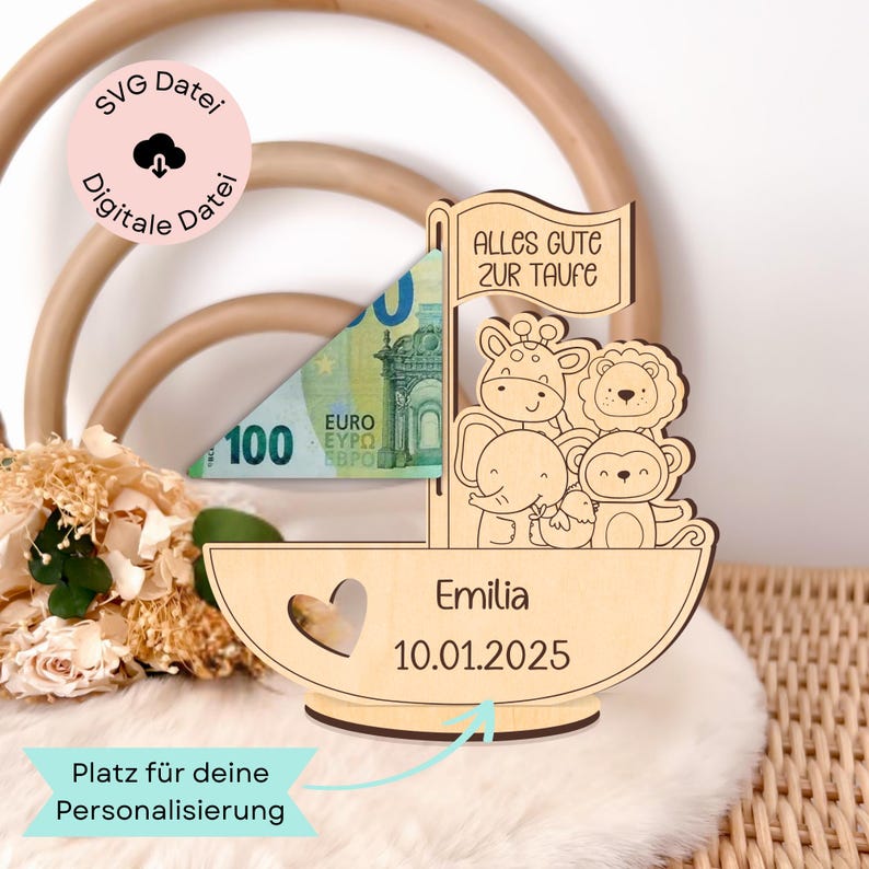 May include: Wooden money box shaped like a boat with a sail that says "Alles Gute zur Taufe". The boat has a heart cutout and is decorated with animal illustrations. The box is personalised with the name "Emilia" and the date "10.01.2025".