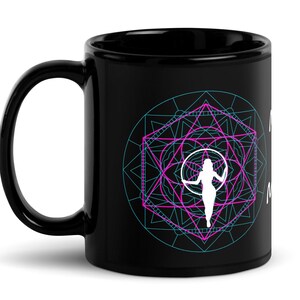May include: Black coffee mug with a white silhouette of a person holding a hoop inside a geometric design with pink and blue lines.