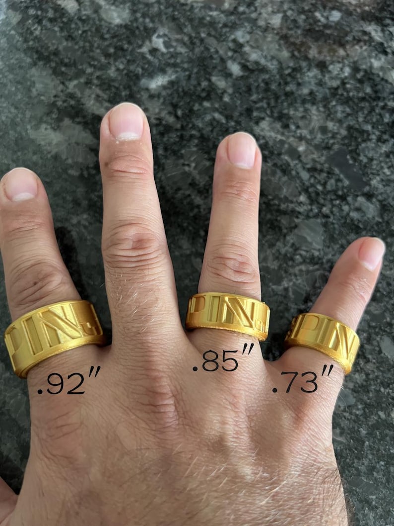 May include: Three gold-coloured bands featuring the embossed letters PIN. The rings are labelled with imperial measurements of .92 inches, .85 inches, and .73 inches respectively, indicating their specific widths or diameters.