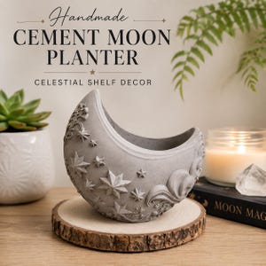 May include: A gray cement moon planter featuring embossed star and swirl patterns on the exterior. The text above the planter reads: Handmade CEMENT MOON PLANTER CELESTIAL SHELF DECOR. The planter is shaped like a crescent moon with a hollow center.
