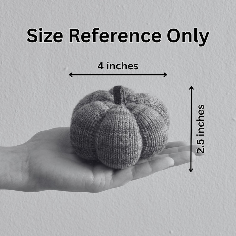 May include: A knitted pumpkin in shades of gray, measuring 4 inches wide and 2.5 inches tall. The pumpkin is held in a hand, with the text "Size Reference Only" above. The pumpkin has a stem and is made of a textured yarn.