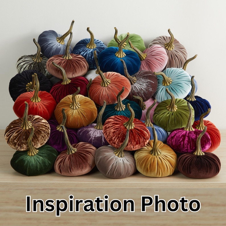 May include: A selection of velvet pumpkins in diverse colours such as blue, green, orange, and pink. Each pumpkin features a gold-toned stem. The words "Inspiration Photo" are displayed at the bottom of the image.