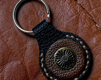 This is a Wheat Leather daisy leather key fob keychain.