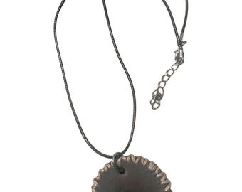 SEO OF 3PCS / Handmade circular pendant necklace featuring a black gunmetal-toned saw blade design with a central stud on a thin dark cord.