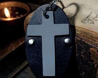 This is a black and grey leather cross pendant necklace.