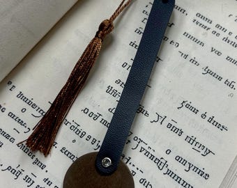 This appears to be a handcrafted leather bookmark with a unique circular base.