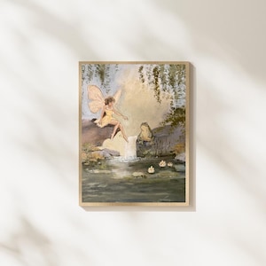May include: A framed artwork depicts a fairy in a yellow dress with butterfly wings, seated near a waterfall. A frog sits nearby. The painting has a soft color palette of greens, yellows, and blues, creating a whimsical scene.