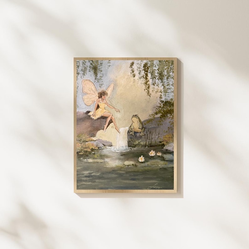 May include: A framed artwork depicts a fairy in a yellow dress with butterfly wings, seated near a waterfall. A frog sits nearby. The painting has a soft color palette of greens, yellows, and blues, creating a whimsical scene.