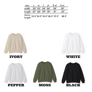May include: Five crewneck sweatshirts in different colors: ivory, white, pepper, moss, and black. The size chart shows measurements in inches for width, length, and sleeve length.