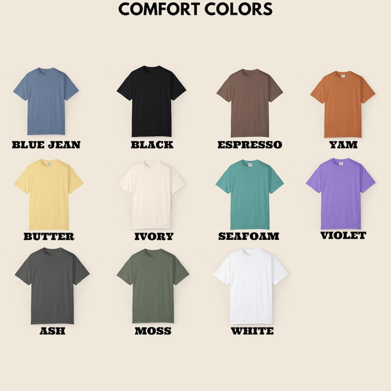 May include: A collection of short-sleeved t-shirts in various colors, including blue jean, black, espresso, yam, butter, ivory, seafoam, violet, ash, moss, and white. The text "COMFORT COLORS" is at the top, with each shirt's color labeled below.