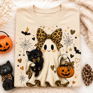 a Halloween-themed t-shirt with a ghost, a cat, a pumpkin, and other Halloween-related elements.