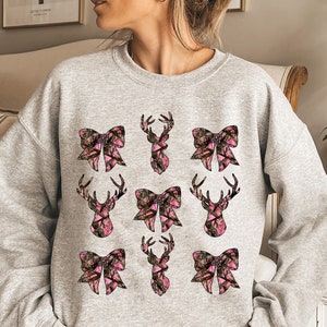 a woman wearing a sweatshirt with a bow on it
