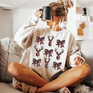 a woman sitting on a couch holding a coffee mug