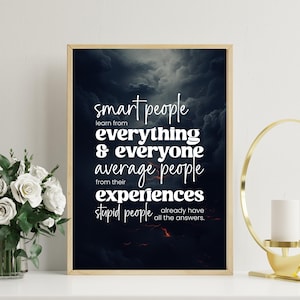 May include: A framed print with a dark, stormy background and white text. The text reads: "smart people learn from everything & everyone, average people from their experiences, stupid people already have all the answers."