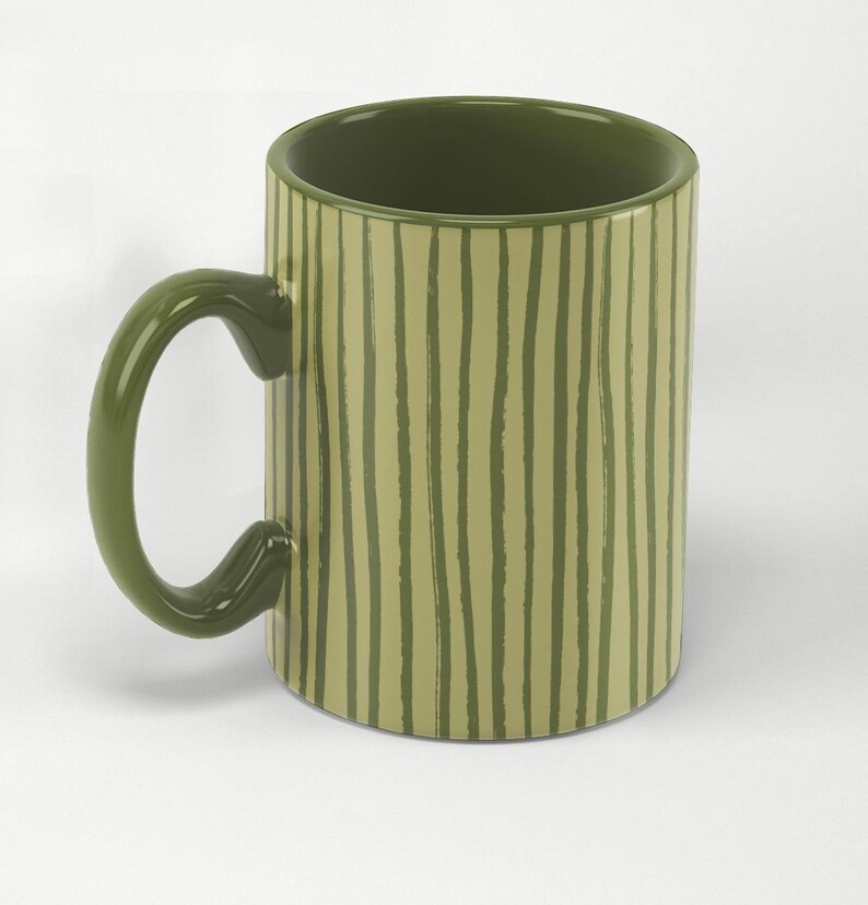 May include: A ceramic mug with a green handle and interior. The exterior features vertical, uneven stripes in a lighter shade of green against a darker green background. The mug is designed for hot or cold beverages.