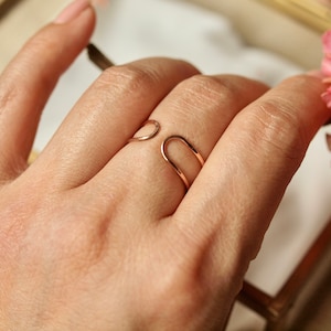 Peut inclure: Une bague en or avec un design ouvert unique. La bague est portée à un doigt.