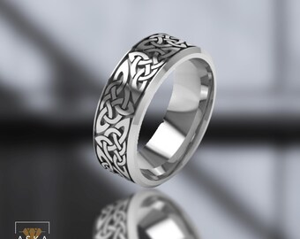 May include: A silver ring with a Celtic knot design. The ring is polished and has a smooth finish.