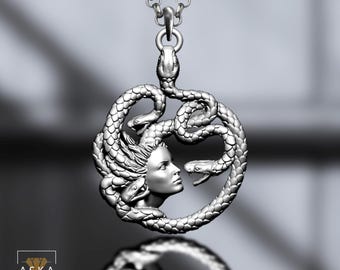 May include: A silver pendant necklace featuring a detailed depiction of Medusa. The pendant showcases Medusa's profile surrounded by coiling snakes, suspended from a delicate chain. The design is intricate and artistic.
