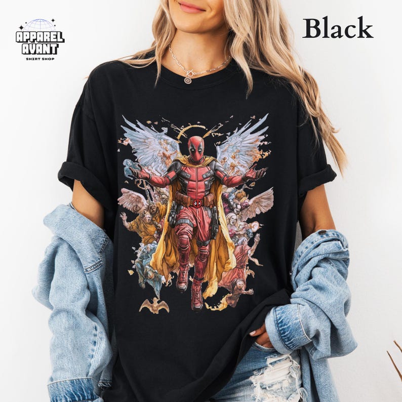Black Comfort Colors t-shirt showcasing Funny Deadpool as Jesus, a hilarious Marvel parody design for fans of the Merc with a Mouth. Soft, heavyweight cotton with a faded wash, relaxed fit, and durable stitching. A bold Deadpool 3 movie graphic tee for lovers of superhero humor, meta-comedy, and sarcastic wit. Ideal for comic book collectors, Ryan Reynolds fans, and those who enjoy Deadpool’s chaotic and unfiltered personality. Perfect for everyday wear or as a standout statement piece.