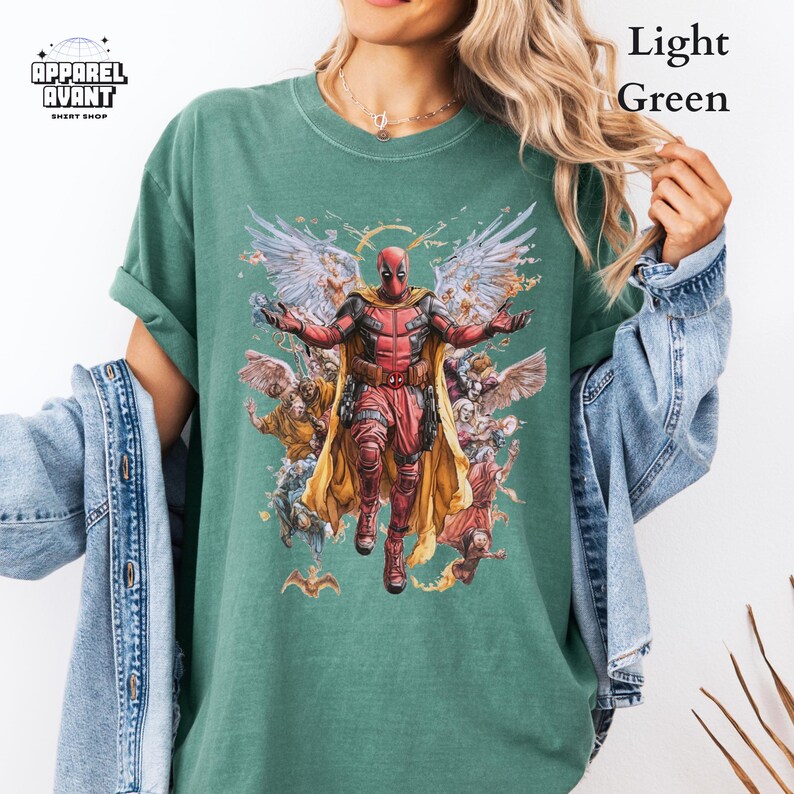Comfort Colors graphic t-shirt featuring Funny Deadpool as Jesus, a laugh-out-loud Marvel parody design. Heavyweight, ultra-soft cotton with a crisp look, relaxed fit, and vintage-style print for a standout aesthetic. The ultimate Deadpool 3 movie shirt for fans of comedic superheroes, unconventional humor, and Marvel’s most unpredictable antihero. Ideal for lovers of sarcasm, meme culture, and Deadpool’s wild, rule-breaking personality. A hilarious addition to any Marvel fan’s collection.