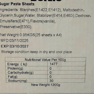 May include: A close-up of a label for sugar paste sheets. The label lists ingredients, net weight, manufacturing and expiration dates, storage conditions, and nutritional information per 100g. The new weight is 1200g.