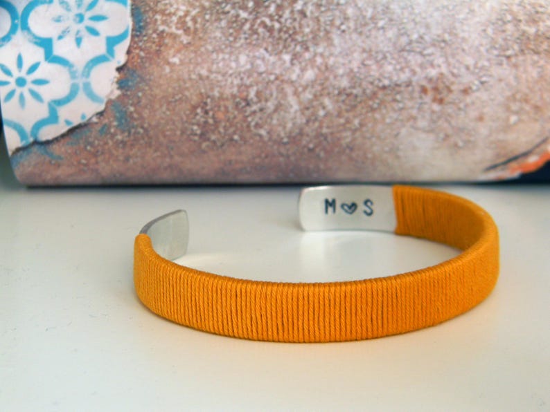 Metal and cotton bracelet with inner personalised engraving. Initials with heart. Yellow cotton thread. Gift for wife, second wedding anniversary gift. Cotton anniversary. The bracelet is adjustable because it has a open part.
