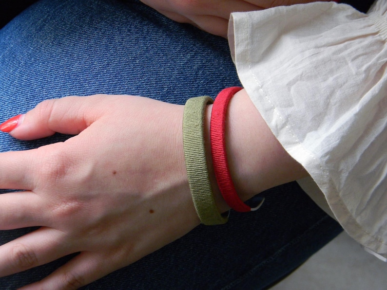 A model wearing personalized metal and cotton bracelets. Custom engraving for cotton anniversary.
