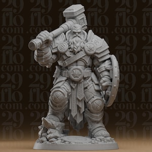 Może przedstawiać: Szara miniaturowa figurka z żywicy przedstawiająca brodatego wojownika w ciężkiej zbroi płytowej, trzymającego duży młot na prawym ramieniu i okrągłą tarczę w lewej dłoni. Postać stoi na skalistej podstawie z misternie wygrawerowanymi detalami.