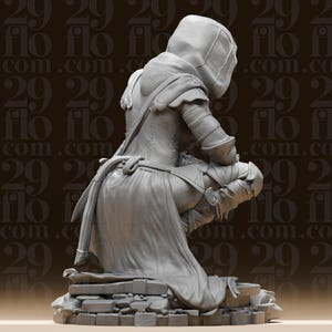 May include: A grey figurine of a person kneeling, wearing a hooded cloak and armour. The figure is posed on a stone base, with intricate details in the clothing and armour. The background has a repeating pattern of the numbers "29" and the word "flo".