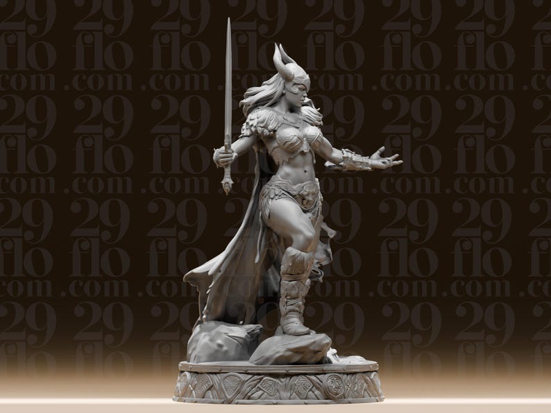 May include: A detailed gray figurine of a warrior woman, holding a sword aloft. She wears a horned helmet, armor, and a flowing cape. The figure stands on a decorative base, with the text "flo" repeated in the background.