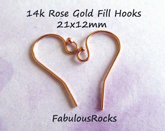 May include: Two 14k rose gold fill earring hooks, each measuring 21x12mm. The hooks are made of a thin, delicate wire and have a small, rounded loop at the top.