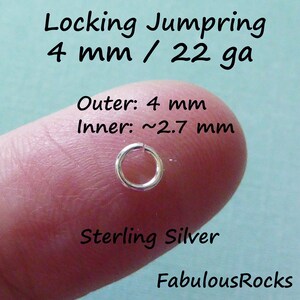 May include: A silver locking jump ring, 4 mm in diameter, with an inner diameter of 2.7 mm. The jump ring is shown on a finger, with the text "Locking Jumpring 4 mm / 22 ga Outer: 4 mm Inner: ~2.7 mm Sterling Silver FabulousRocks" visible in the background.