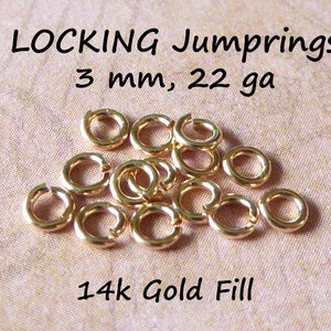 May include: A close-up of 14k gold filled jump rings. The rings are 3 mm in diameter and 22 gauge.  LOCKING Jump rings, 3 mm, 22 ga, 14k Gold Fill.